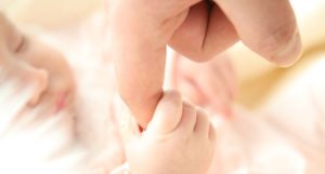 hand holding baby's hand