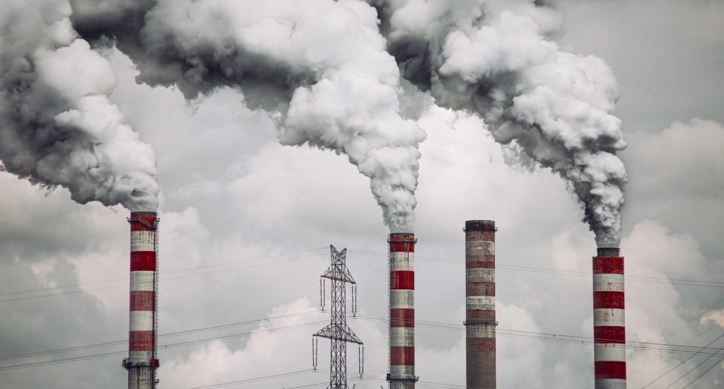 Large chimneys at a power station releasing smoke