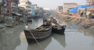 Large boats on a low river in a city