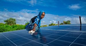 A woman cleaning a solar panel