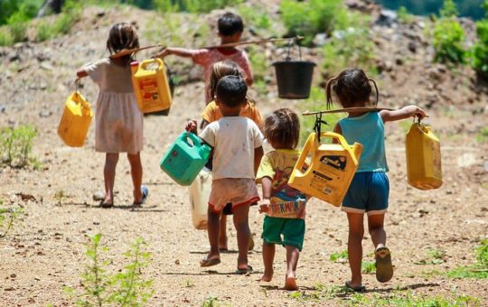Children carrying water containers