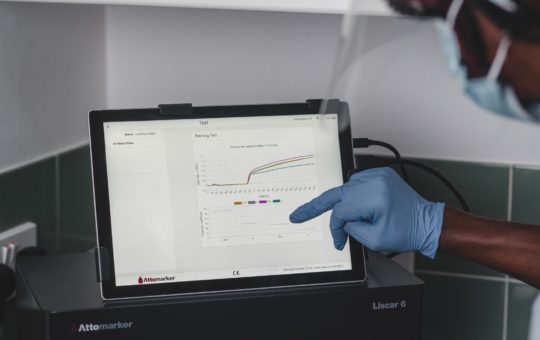 A scientist looking at a graph on a computer screen
