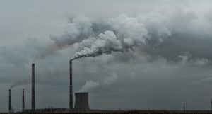 Smoke pouring from large industrial chimneys