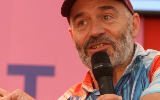 Richard Betts speaking into a microphone