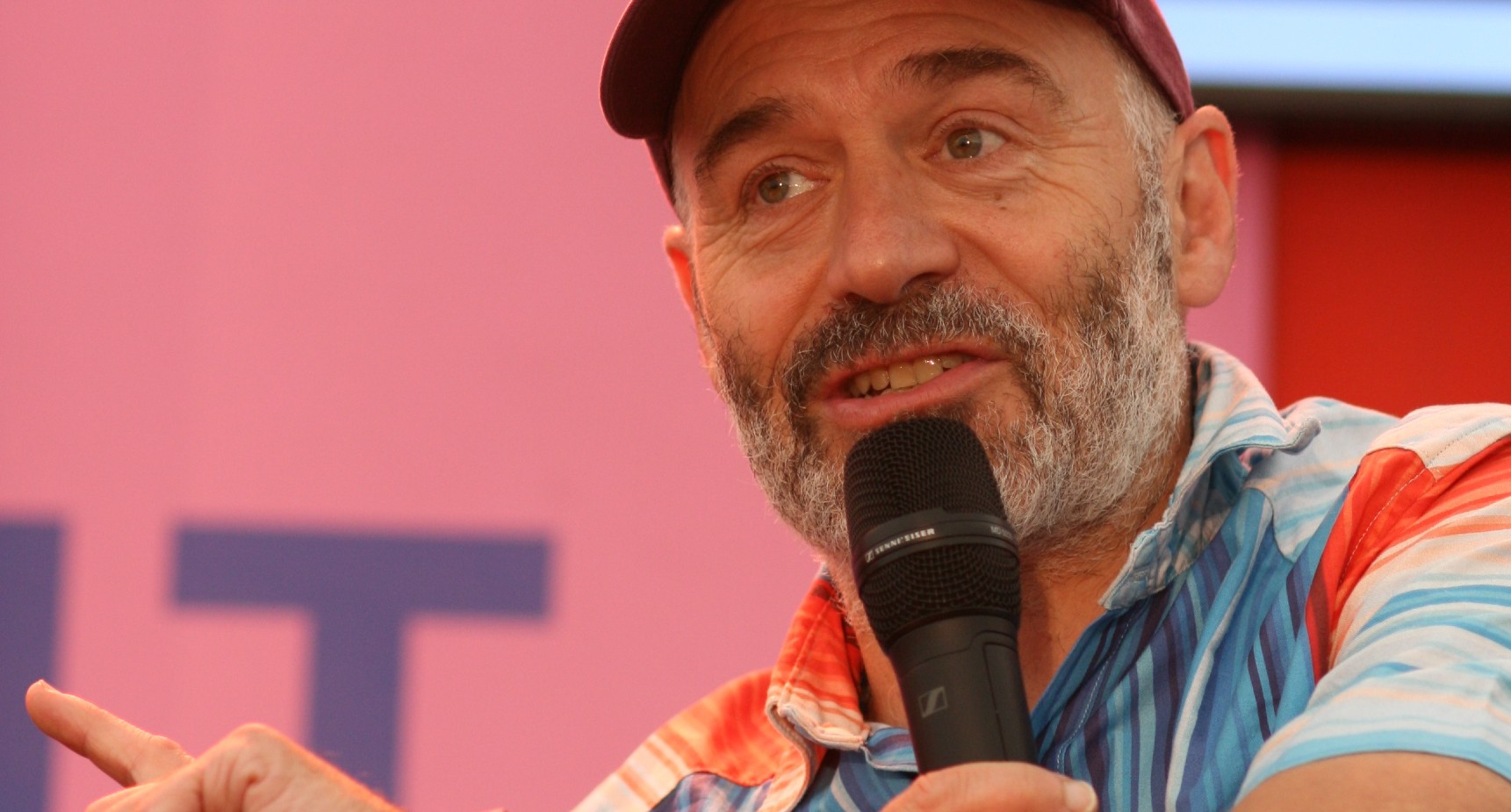 Richard Betts speaking into a microphone