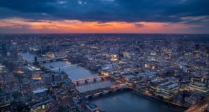 A view of London at sunset, with a large portion of the city's rooftops visible