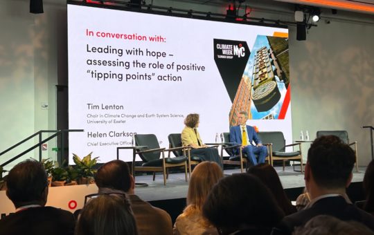 Professor Tim Lenton on stage in New York with Helen Clarkson, CEO of Climate Group