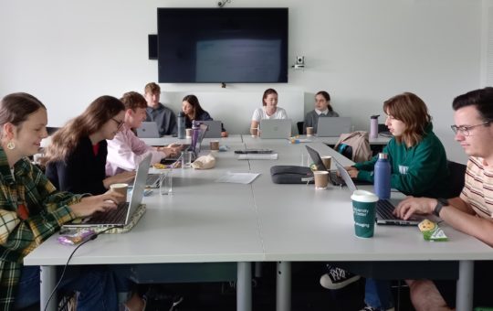 Students sitting at desks in a seminar room