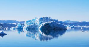 Fragments of ice in the sea, under clear skies