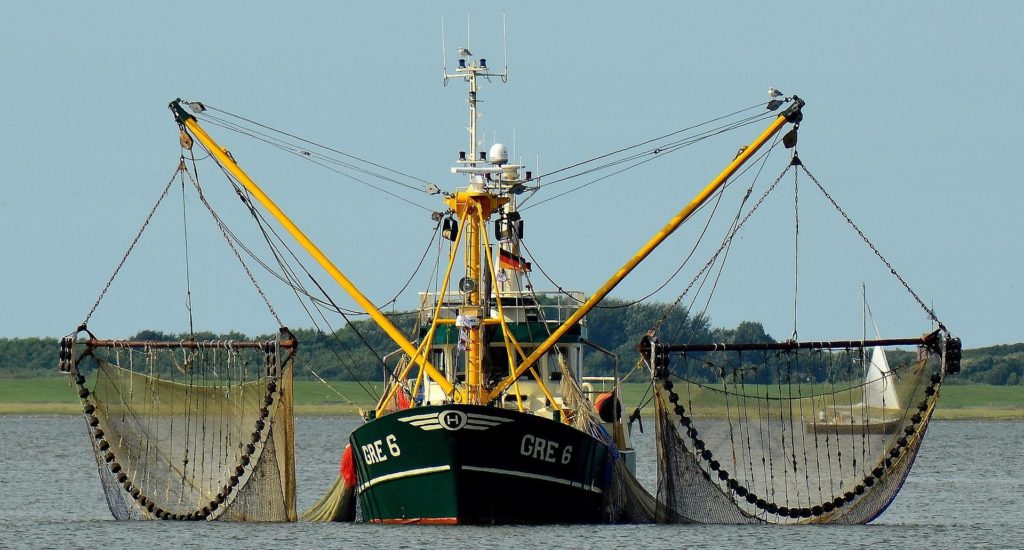 A trawler with nets hanging either side