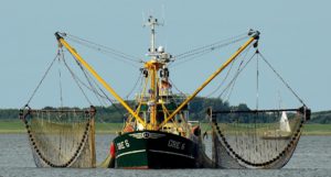 A trawler with nets hanging either side