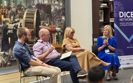 Four people on a panel on a stage at the DICE+ launch