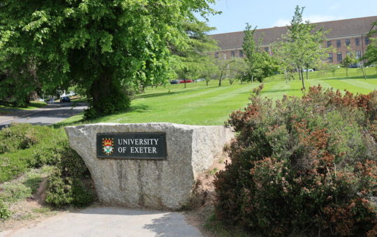 The large stone bearing the words University of Exeter at the edge of campus