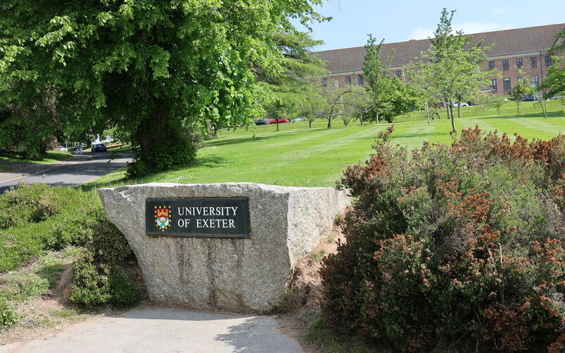 The large stone bearing the words University of Exeter at the edge of campus