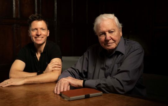 Colin Butfield and Sir David Attenborough sitting together at a table