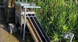 An eel pass - a sloping metal structure with three channels and pipes