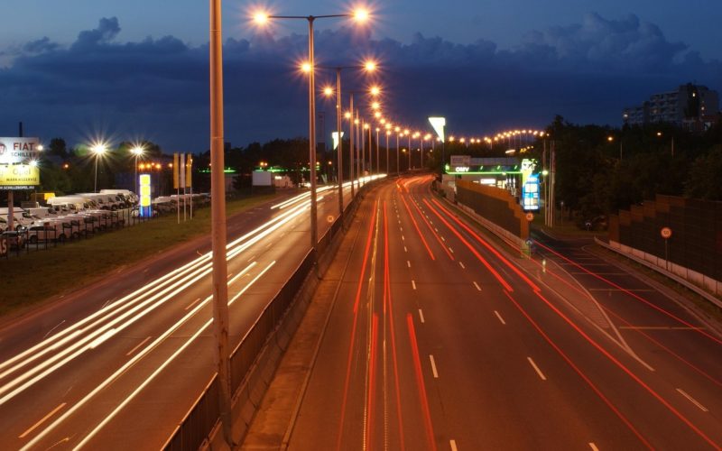 An image showing a motorway at night, with vehicle lights blurred into streams.