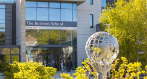 An external photo of the entrance to Building:One, the Business School, at the University of Exeter.