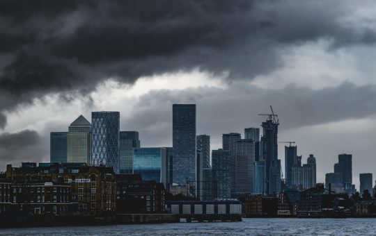 The City of London skyline seen under dark clouds