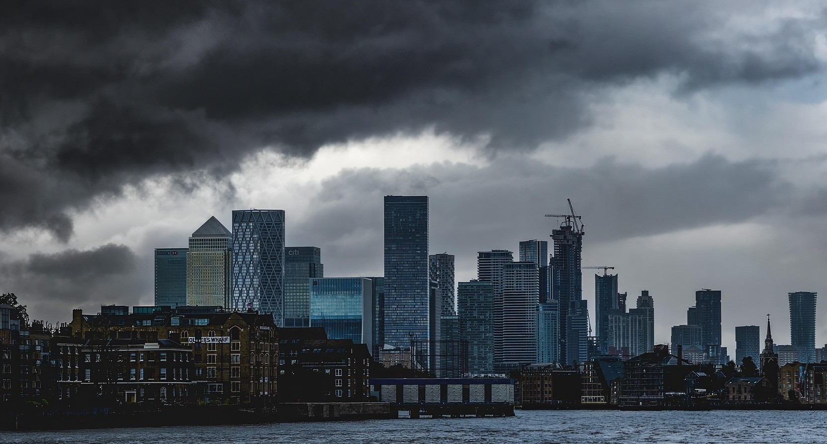 The City of London skyline seen under dark clouds
