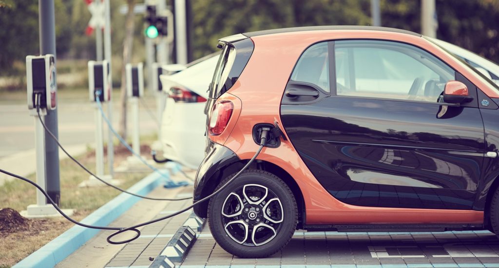 A line of electric cars attached to chargers