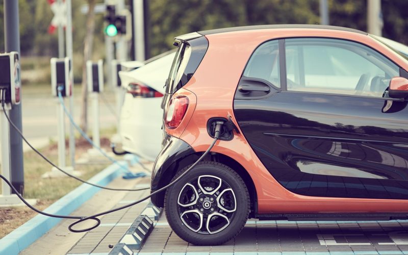 A line of electric cars attached to chargers