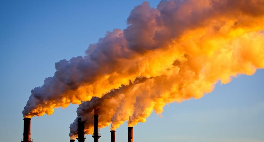 Factory chimneys sending smoke into the air