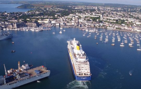 Falmouth Harbour seen from the air, with a large cruise ship arriving