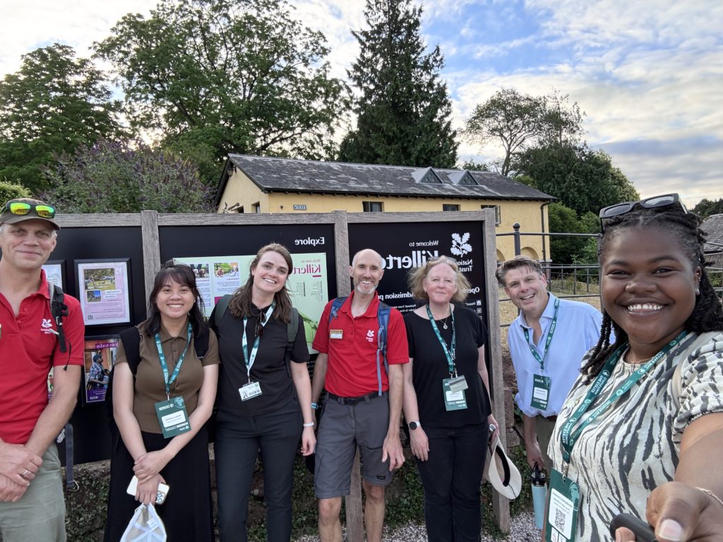 A group of people posting outdoor for a selfie at Killerton House